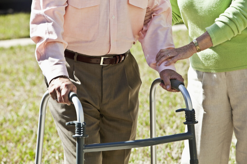 Midsection, senior couple with walker