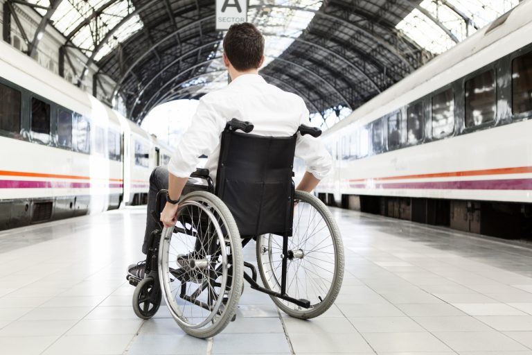 Man on wheelchair waiting for the train