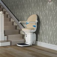 Handicare 1000 stairlift in cream at the bottom of the stairs
