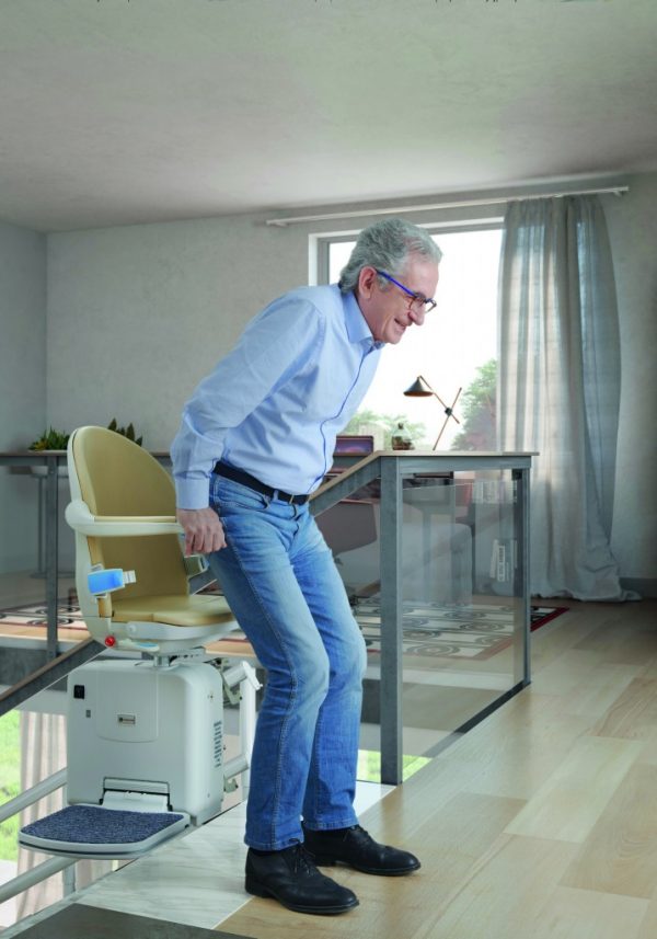 Handicare 2000 stairlift with a man getting out of the chair