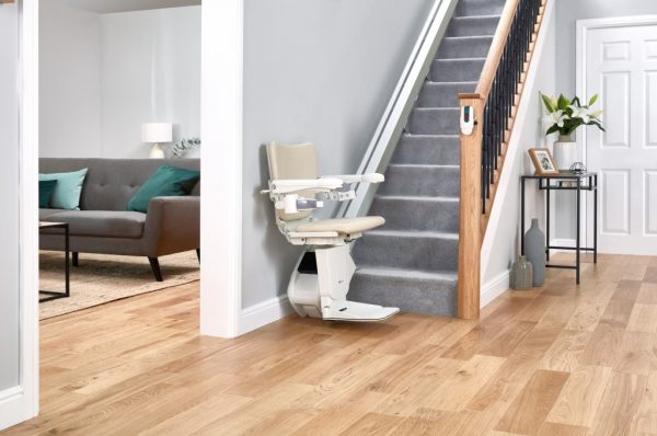 Handicare 1100 Stairlift installed on stairs, positioned at the bottom