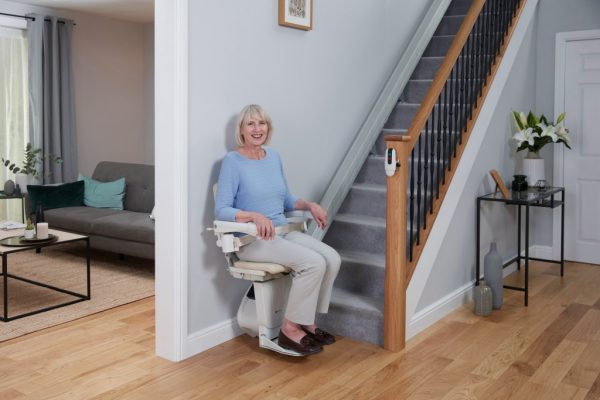 Handicare 1100 Stairlift with a lady sat on it
