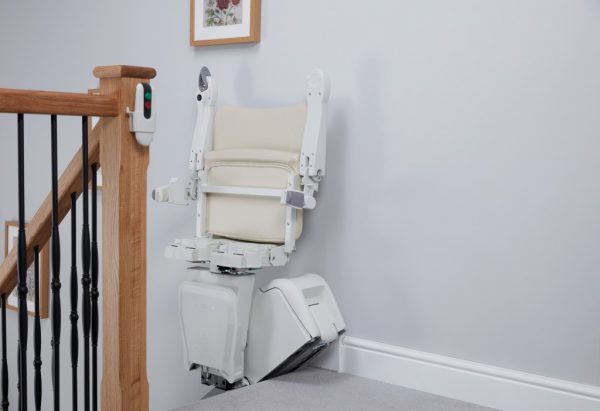 Handicare 1100 Stairlift folded up at the top of the stairs