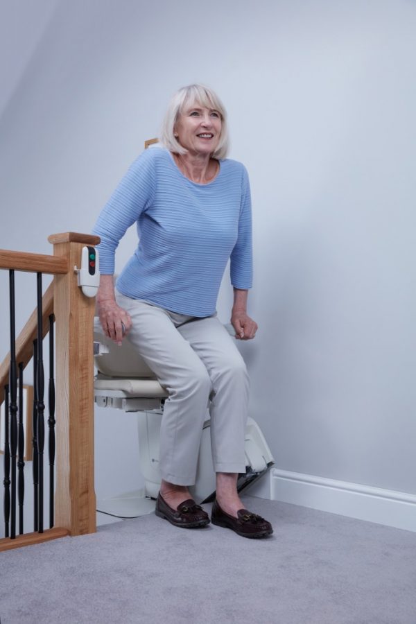 Handicare 1100 Stairlift with a lady getting out of it